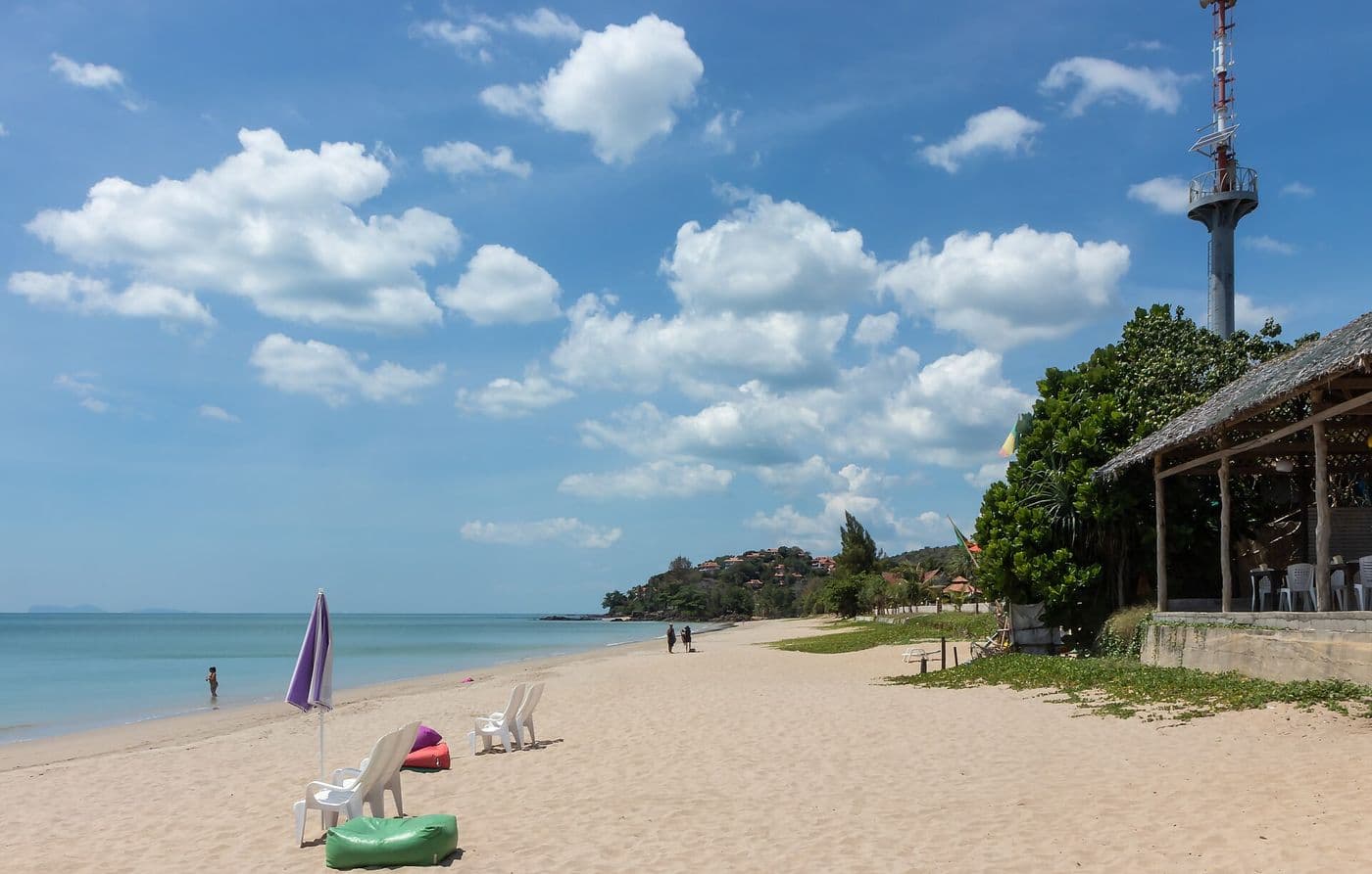 Wide sand and a deep blue sky over the northern end of Klong Nin Beach
