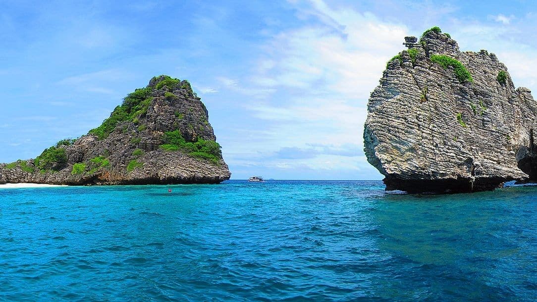 Longtail boat and limestone islands near Koh Lanta, Krabi, Thailand